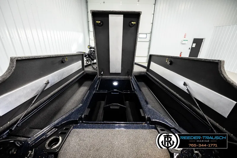 Slide: The Image of 2024 Bass Tracker NitroZ20 boat interior storage compartments in a showroom. - 21