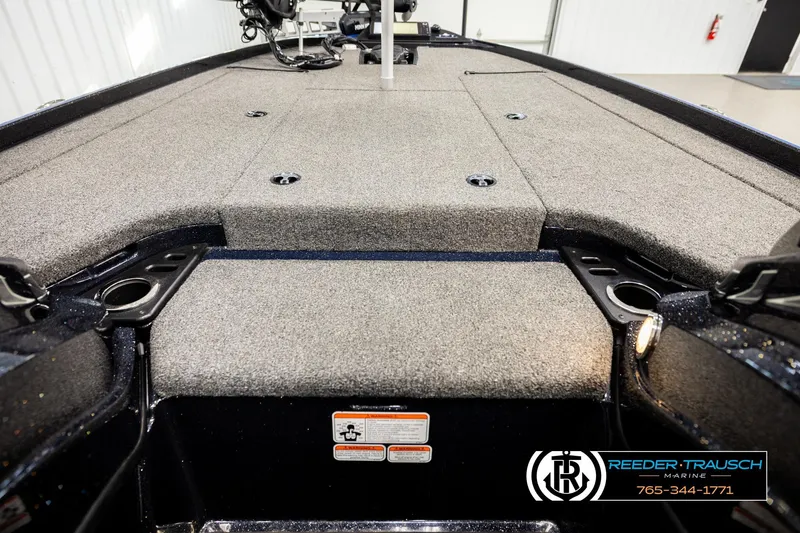 Slide: The Image of 2024 Bass Tracker NitroZ20 boat deck with carpeted surface and storage compartments. - 22