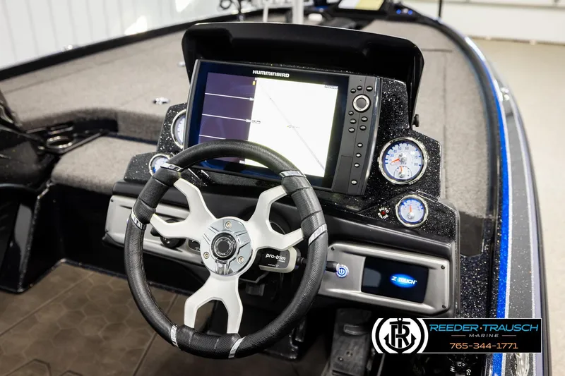 Slide: The Image of 2024 Bass Tracker Nitro Z20 boat dashboard with steering wheel and navigation display. - 26