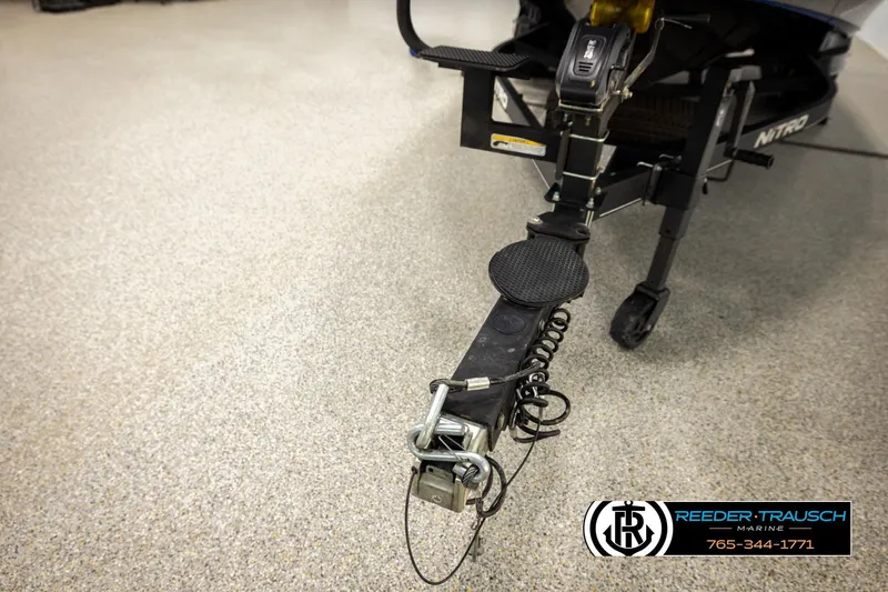 Slide: The Image of 2024 Bass Tracker NitroZ20 trailer hitch in showroom, Reeder-Trausch Marine logo visible. - 63