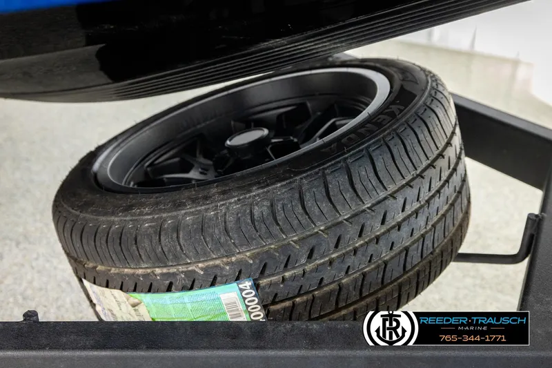 Slide: The Image of 2024 Bass Tracker NitroZ20 trailer tire with black rim, displayed at Reeder-Trausch Marine. - 65