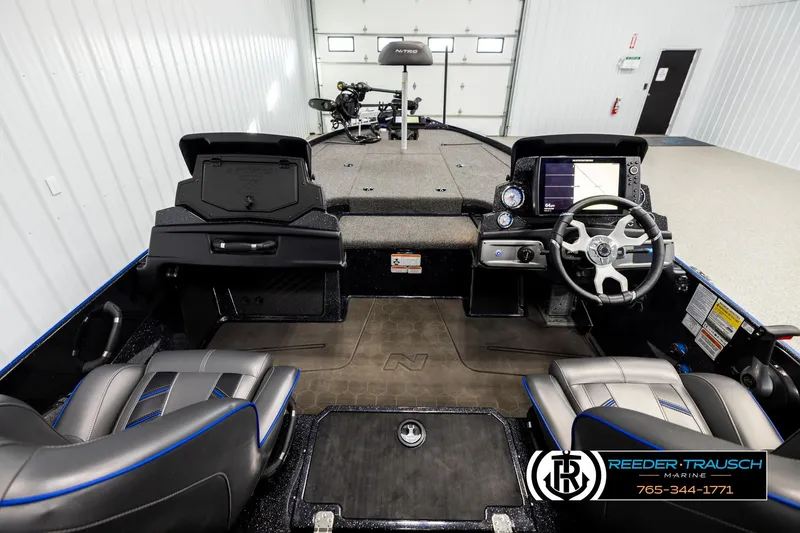 Slide: The Image of 2024 Bass Tracker Nitro Z20 boat interior with steering console and seating. - 13