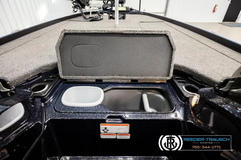 Slide: The Image of 2024 Bass Tracker Nitro Z20 boat interior with storage compartment and cup holders. - 23