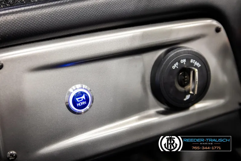 Slide: The Image of 2024 Bass Tracker NitroZ20 dashboard with horn button and ignition switch. - 29