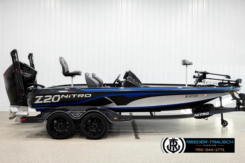 Slide: The Image of 2024 Bass Tracker Nitro Z20 boat, side view, in showroom setting. - 4