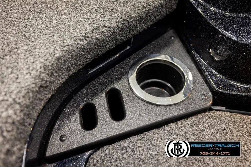 Slide: The Image of 2024 Bass Tracker Nitro Z20 boat cup holder and carpeted interior detail. - 45
