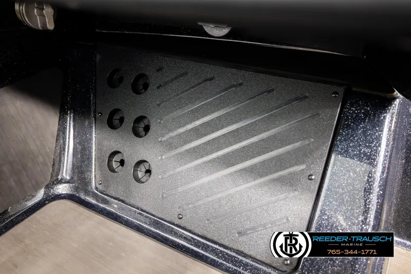 Slide: The Image of 2024 Bass Tracker NitroZ20 boat interior detail with textured panel and Reeder-Trausch Marine logo. - 56