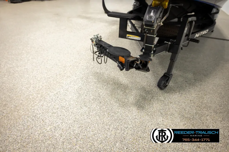 Slide: The Image of 2024 Bass Tracker NitroZ20 trailer hitch in showroom, Reeder-Trausch Marine logo visible. - 62