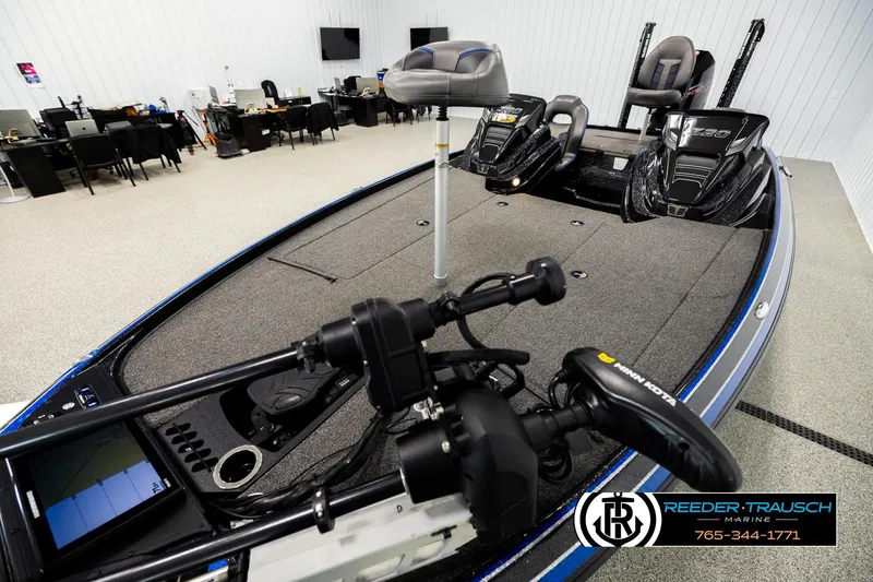 Slide: The Image of 2024 Bass Tracker Nitro Z20 boat interior with advanced controls in showroom. - 9