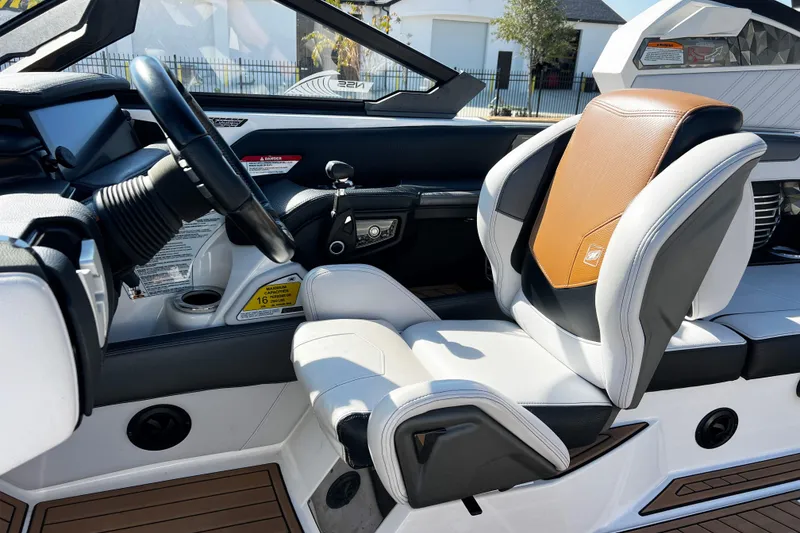 Slide: The Image of 2019 Nautique Super Air Nautique G23 interior with modern steering and seating design. - 10