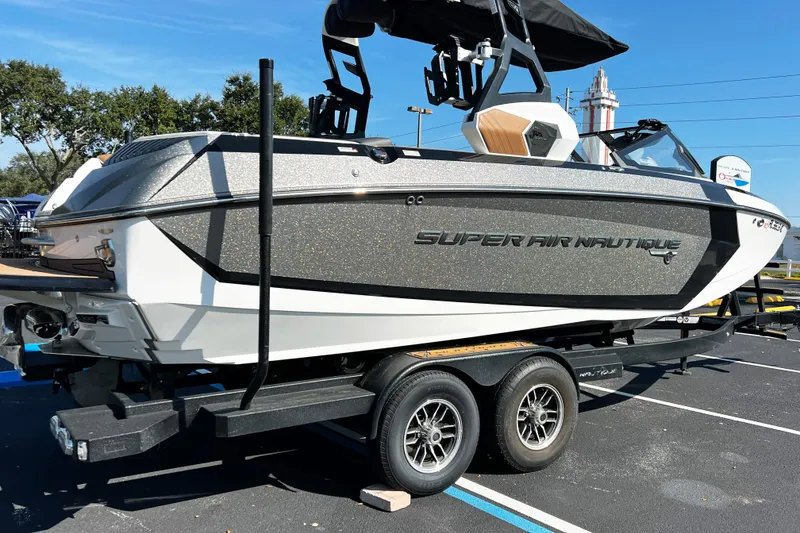 Slide: The Image of 2019 Nautique Super Air Nautique G23 boat on trailer, parked outdoors. - 3