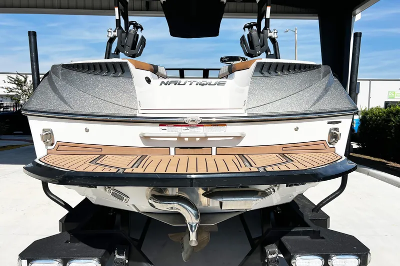 Slide: The Image of 2019 Nautique Super Air Nautique G23 boat rear view with teak deck. - 4