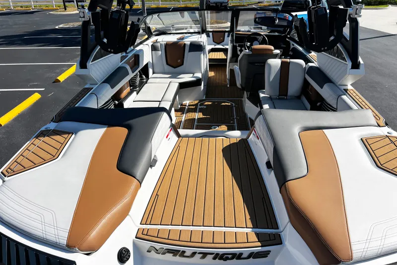 Slide: The Image of 2019 Nautique Super Air Nautique G23 interior with luxurious seating and teak flooring. - 8
