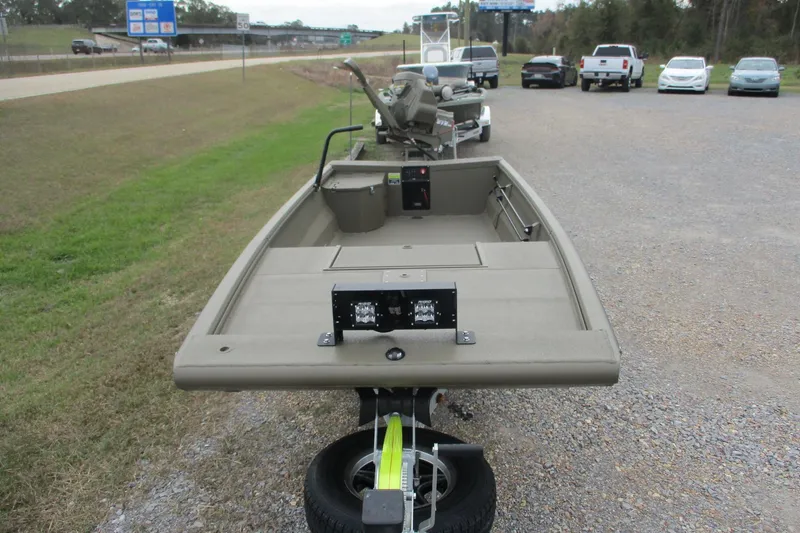 Slide: The Image of 2026 Gator Tail 1748 GATOR boat on trailer, parked near highway. - 2