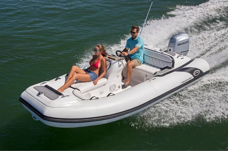 Slide: The Image of Manufacturer Provided Image: 2025 Walker Bay Generation 450 DLX boat cruising with two passengers on open water. - 2