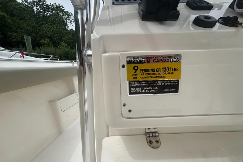 Slide: The Image of 2024 Key West 239 FS boat capacity label, maximum 9 persons or 1301 lbs. - 10