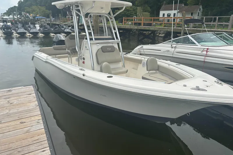 Slide: The Image of 2024 Key West 239 FS boat docked in a marina, showcasing sleek design and spacious seating. - 3