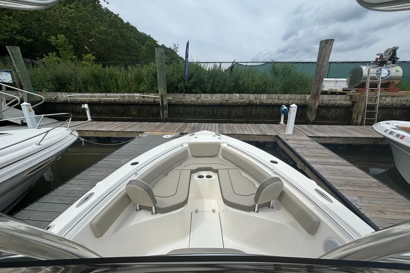 Slide: The Image of 2024 Key West 239 FS boat docked at a marina, featuring spacious seating. - 4