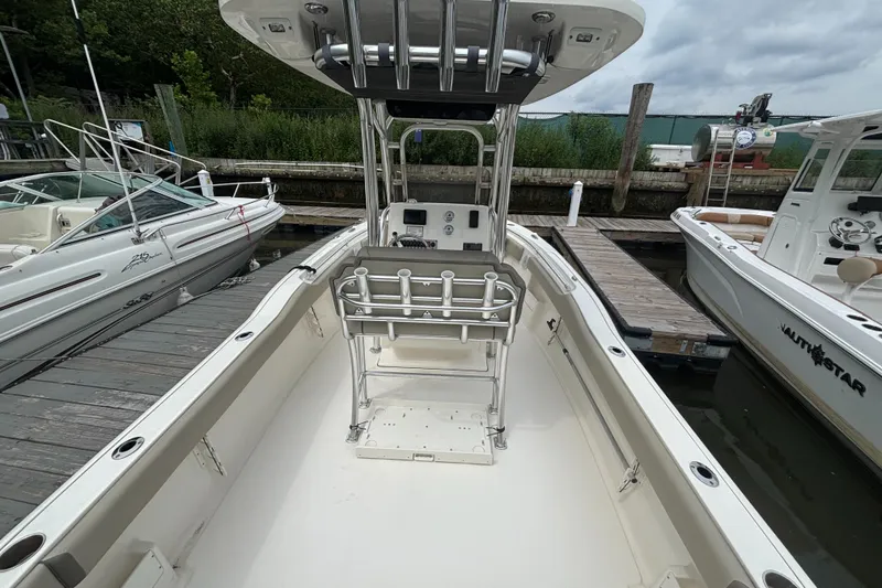 Slide: The Image of 2024 Key West 239 FS boat docked, featuring spacious deck and center console. - 6