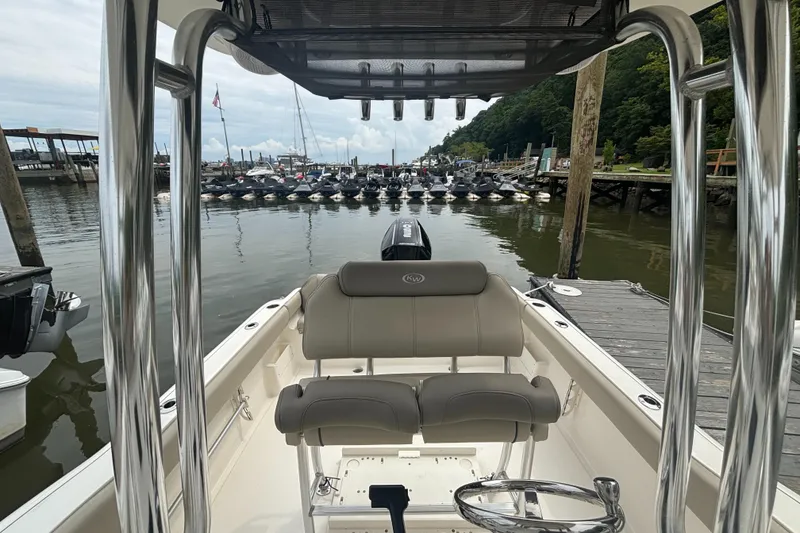 Slide: The Image of 2024 Key West 239 FS boat docked at marina, featuring sleek seating and polished metalwork. - 7