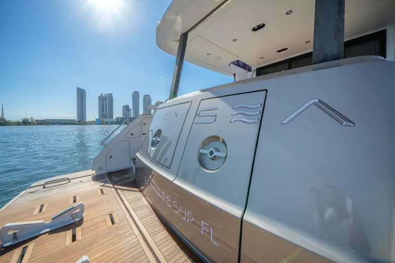 Slide: The Image of 2023 Azimut Fly 68 yacht docked with city skyline in background. - 34