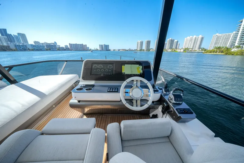 Slide: The Image of 2023 Azimut Fly 68 yacht helm with city skyline and water view. - 38