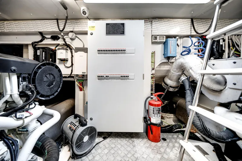 Slide: The Image of Engine room of 2023 Azimut Fly 68 yacht with control panel and fire extinguisher. - 49