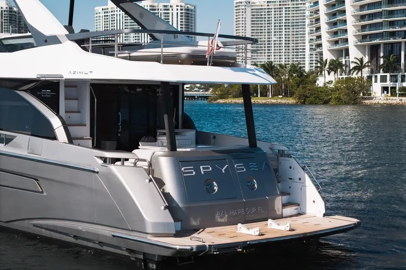 Slide: The Image of 2023 Azimut Fly 68 yacht docked near modern waterfront buildings. - 53