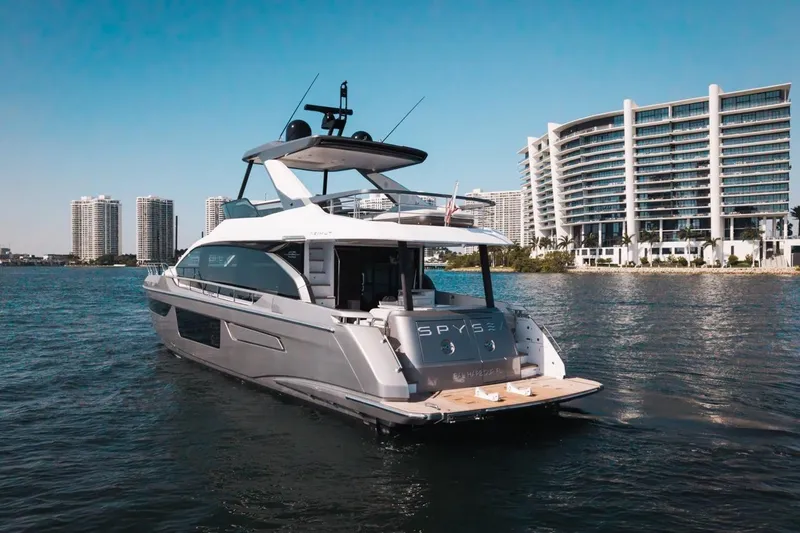 Slide: The Image of 2023 Azimut Fly 68 yacht on water with modern buildings in background. - 54