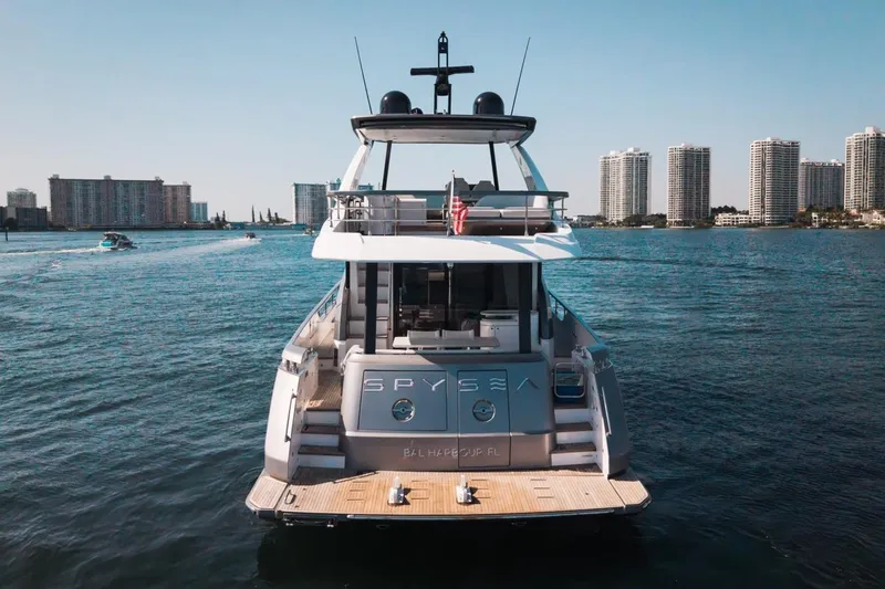 Slide: The Image of 2023 Azimut Fly 68 yacht on water with city skyline backdrop. - 55