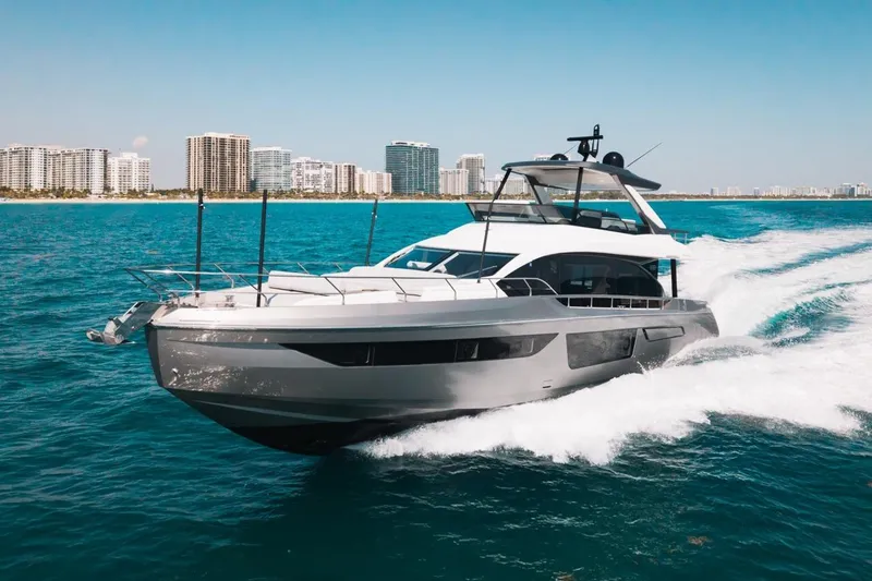 Slide: The Image of 2023 Azimut Fly 68 yacht cruising on blue ocean near city skyline. - 57