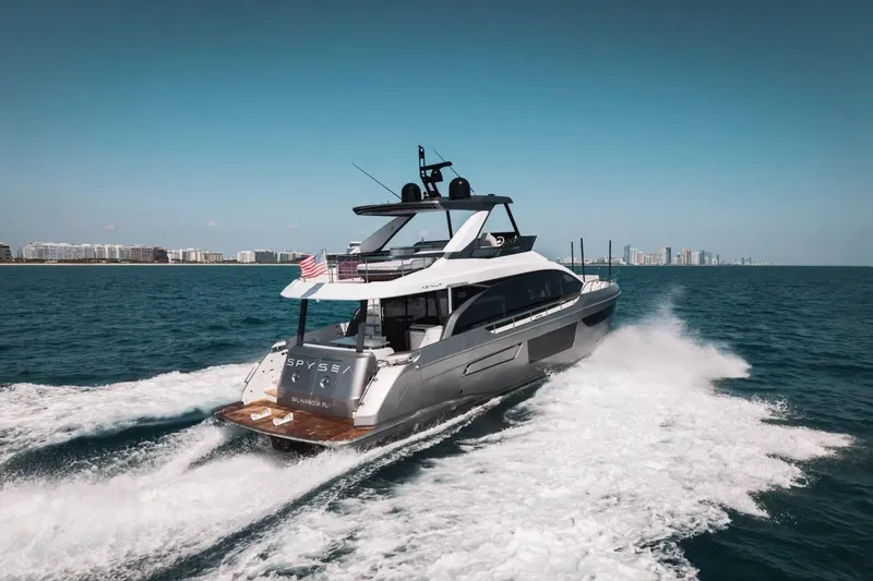 Slide: The Image of 2023 Azimut Fly 68 yacht cruising on open water near city skyline. - 65