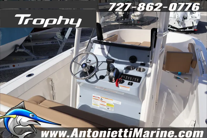 Slide: The Image of 2026 Bayliner Trophy T22CC boat interior with steering wheel and controls, displayed by Antonietti Marine. - 12