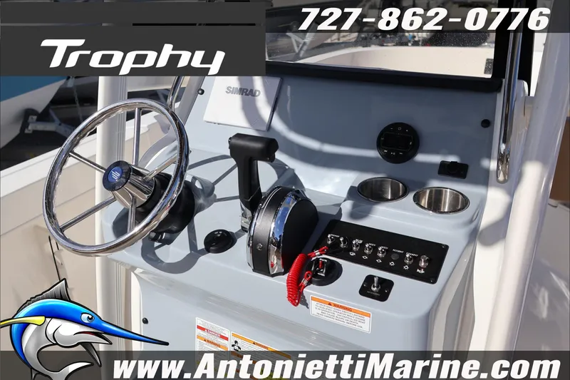 Slide: The Image of 2026 Bayliner Trophy T22CC boat console with steering wheel and controls. - 14