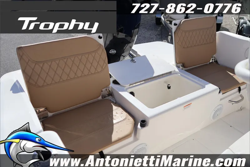 Slide: The Image of 2026 Bayliner Trophy T22CC boat seating and storage area, featuring tan cushions. - 24