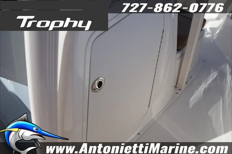 Slide: The Image of 2026 Bayliner Trophy T22CC boat interior detail with contact information and logo. - 29