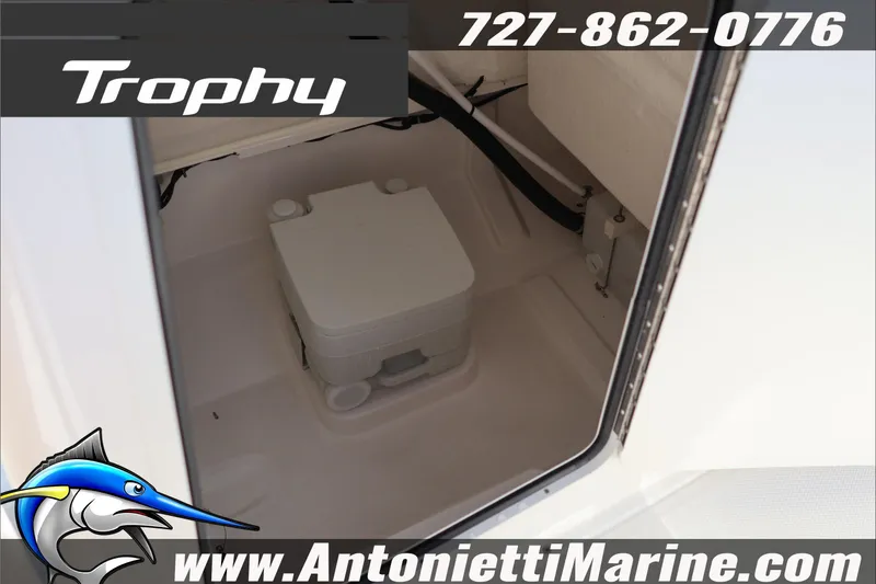 Slide: The Image of 2026 Bayliner Trophy T22CC boat storage compartment with portable toilet, Antonietti Marine branding. - 30