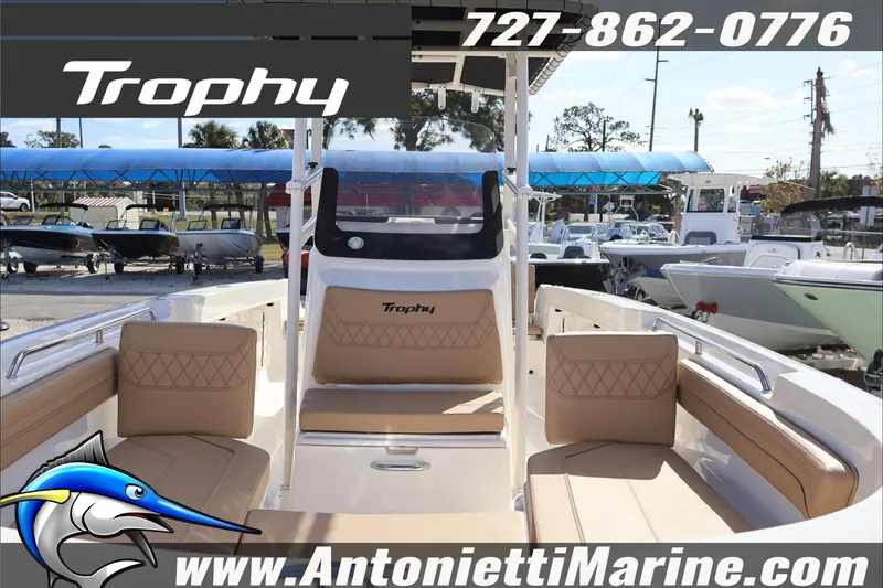 Slide: The Image of 2026 Bayliner Trophy T22CC boat interior with tan seating, displayed at Antonietti Marine. - 8