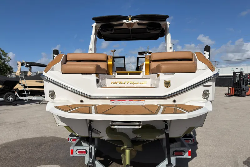 Slide: The Image of 2025 Nautique Super Air Nautique G25 Paragon boat, rear view, on trailer, sunny day. - 11