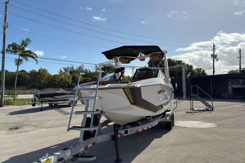 Slide: The Image of 2025 Nautique Super Air Nautique G25 Paragon on trailer under clear sky. - 15