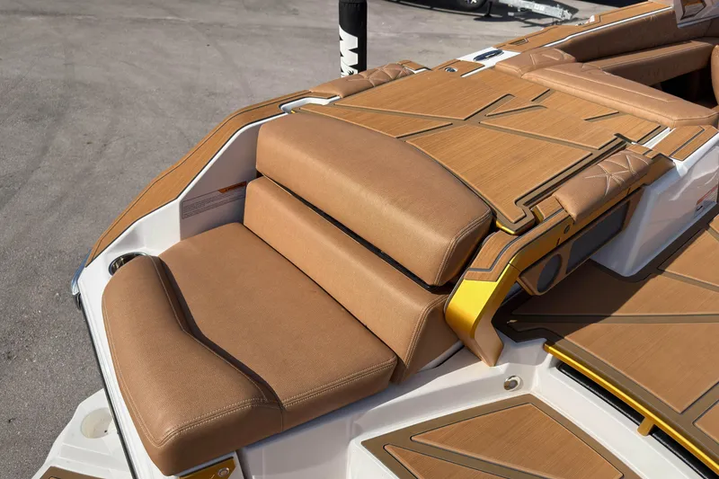 Slide: The Image of 2025 Nautique Super Air Nautique G25 Paragon boat with luxurious tan seating and deck. - 18