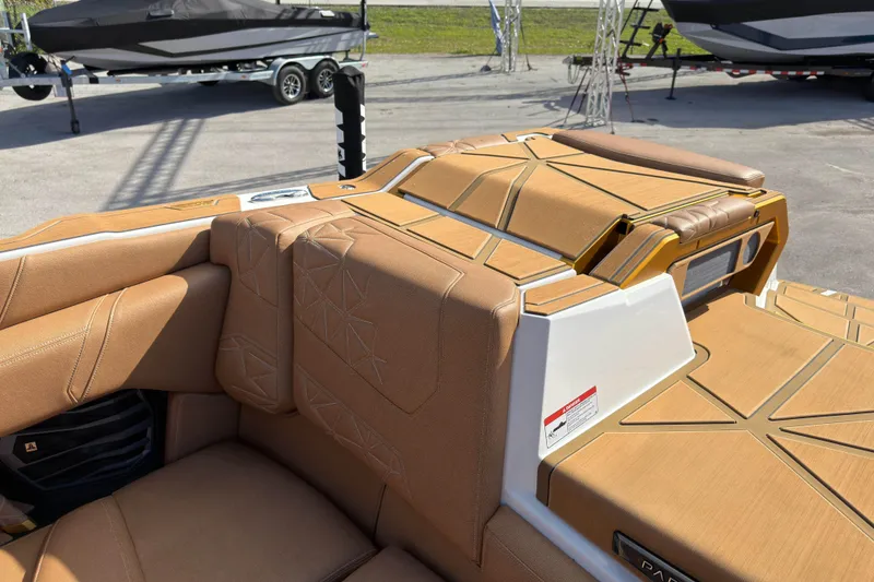 Slide: The Image of 2025 Nautique Super Air Nautique G25 Paragon interior with tan upholstery and modern design. - 20