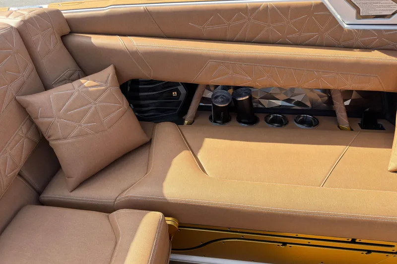 Slide: The Image of Luxurious interior of 2025 Nautique Super Air Nautique G25 Paragon with plush seating and cup holders. - 22