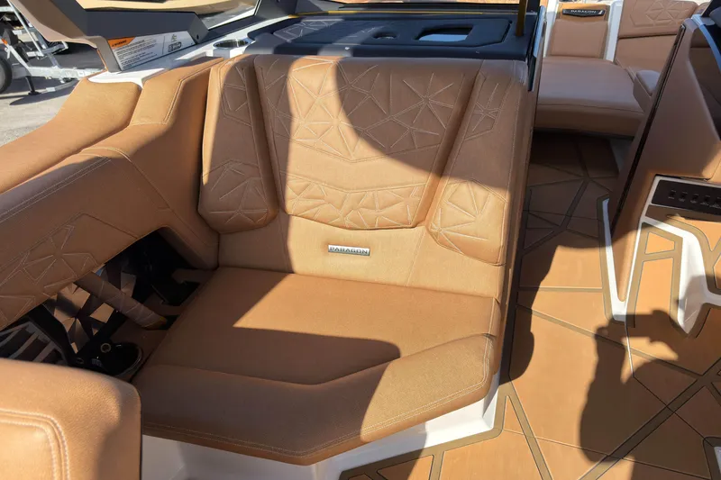 Slide: The Image of 2025 Nautique Super Air Nautique G25 Paragon interior with tan upholstery and geometric design. - 23