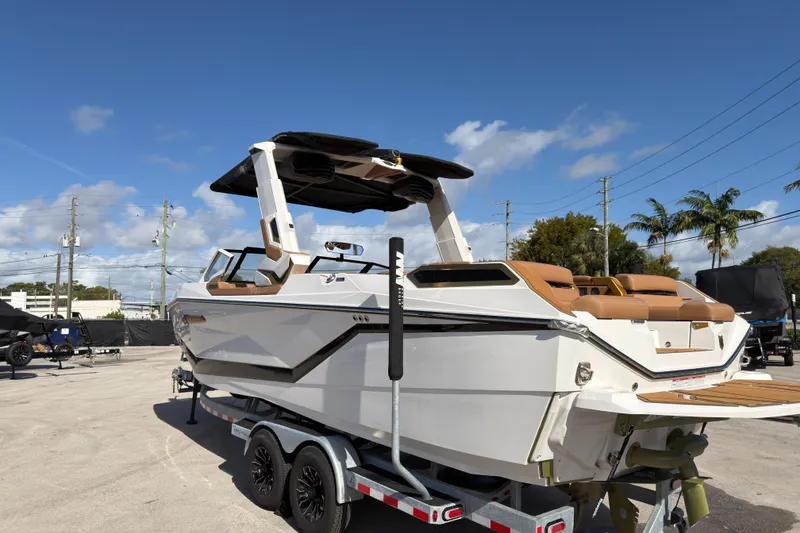 Slide: The Image of 2025 Nautique Super Air Nautique G25 Paragon boat on trailer under clear blue sky. - 4