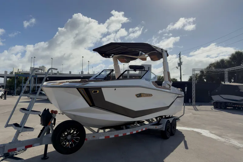 Slide: The Image of 2025 Nautique Super Air Nautique G25 Paragon boat on trailer under sunny sky. - 6