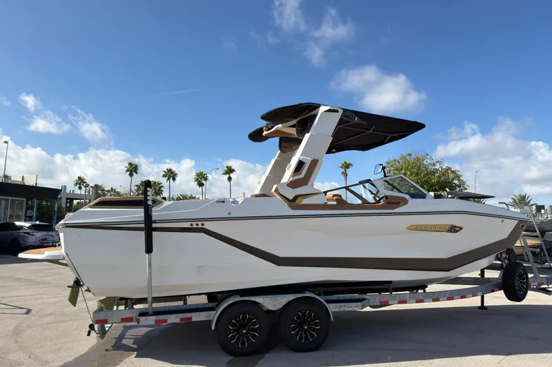Slide: The Image of 2025 Nautique Super Air Nautique G25 Paragon boat on trailer under clear sky. - 9