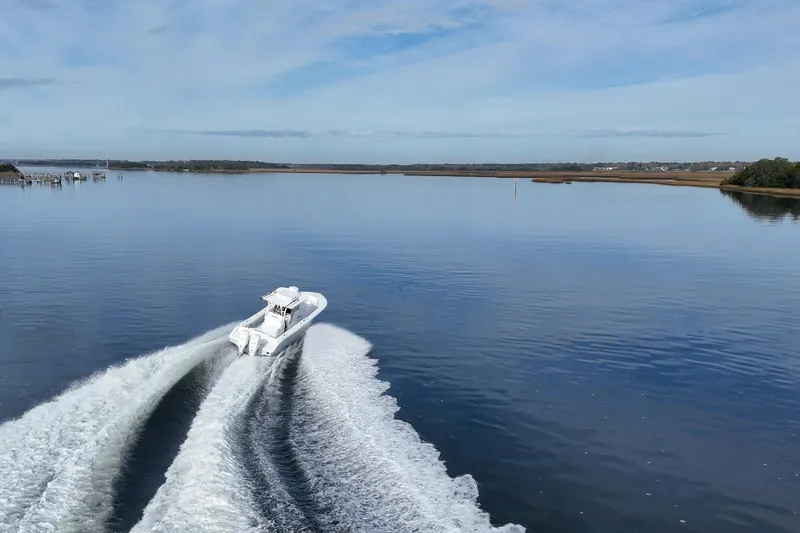 Slide: The Image of 2023 Yellowfin 32 Offshore boat cruising on calm waters under a clear sky. - 1