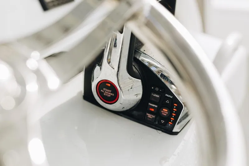 Slide: The Image of Close-up of 2023 Yellowfin 32 Offshore boat controls and steering wheel. - 11