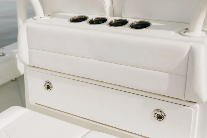 Slide: The Image of 2023 Yellowfin 32 Offshore boat seating with cup holders and storage. - 17